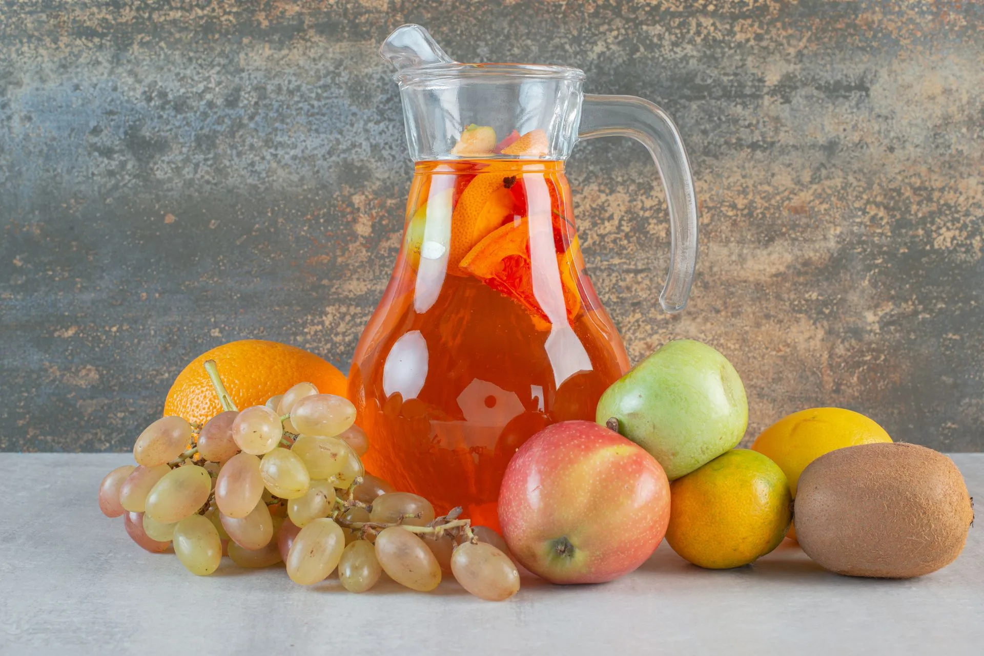 a-glass-jug-of-juice-with-fruits-on-marble